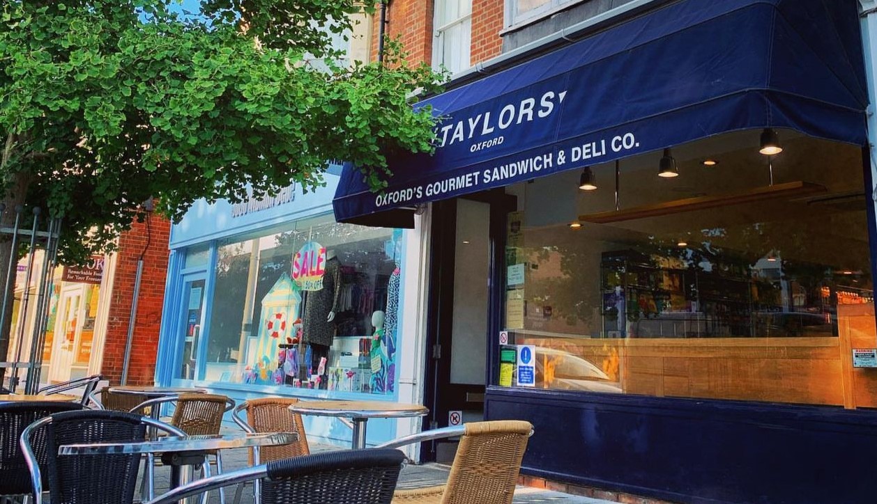 Taylors Oxford storefront with dark blue awning